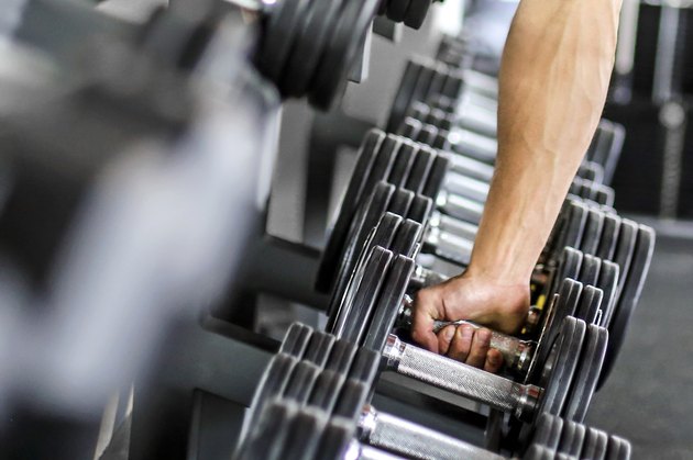 View of a man's hand gripping a barbell
