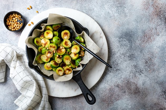 Roasted, fried, grilled crispy brussels sprouts with pine nuts, salt and pepper