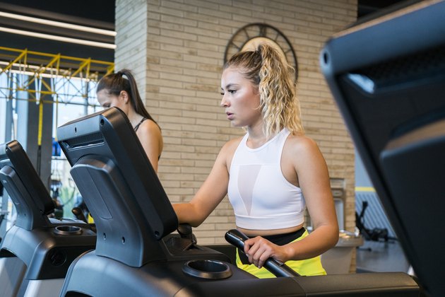Woman wearing sportswear on top of a treadmill
