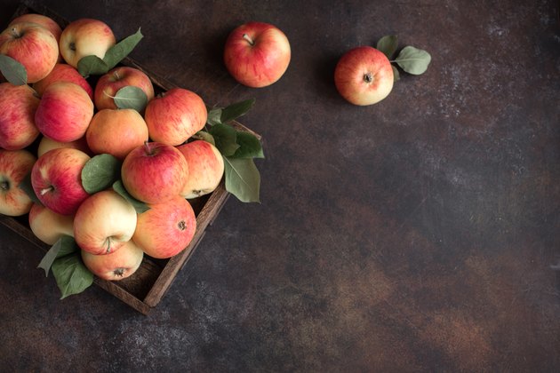 Red apples in wooden box