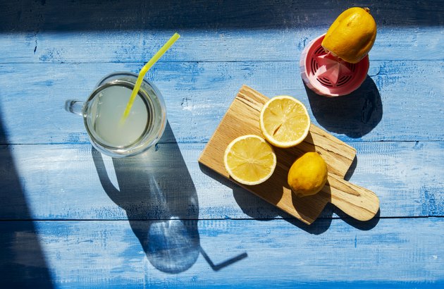 Lemons and citrus squeezer on a wooden background