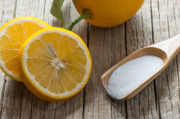 Lemon and Carbonate powder or baking soda on wooden table, alternative medicine, organic cleaner