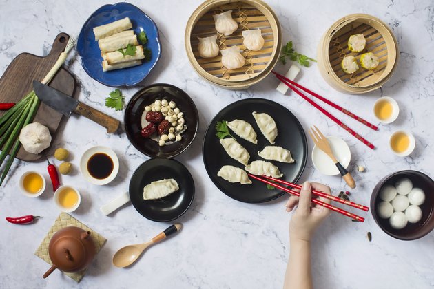 Flat lay Chinese new year reunion dinner, food and drink. Marble top background.