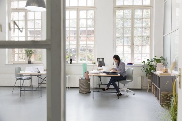 Woman working at desk in a loft office