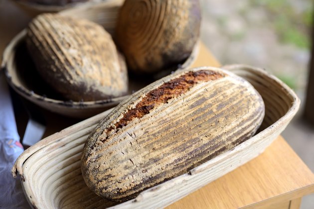 freshly baked bread from the stone oven lying in baskets to cool down