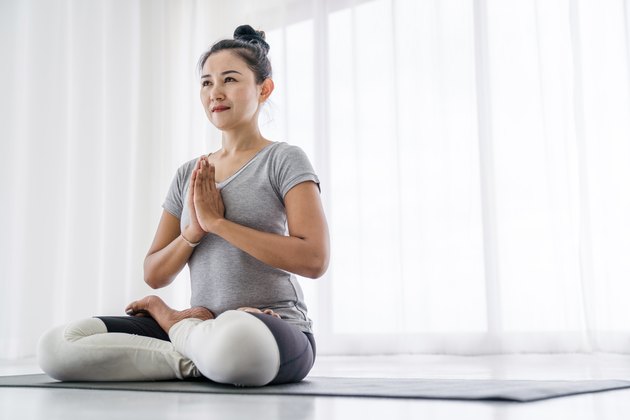 Woman doing yoga exercises at home
