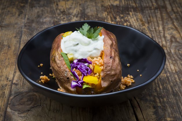 Sweet potato Kumpir withbell pepper, red cabbage, couscous, yoghurt sauce and parsley