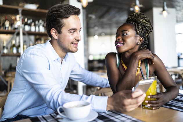Couple drinking coffee and juice in cafeteria