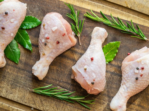 Chicken legs with spices and salt ready for cooking.