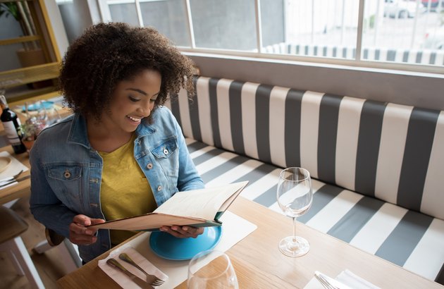 woman looking at a menu in a restaurant