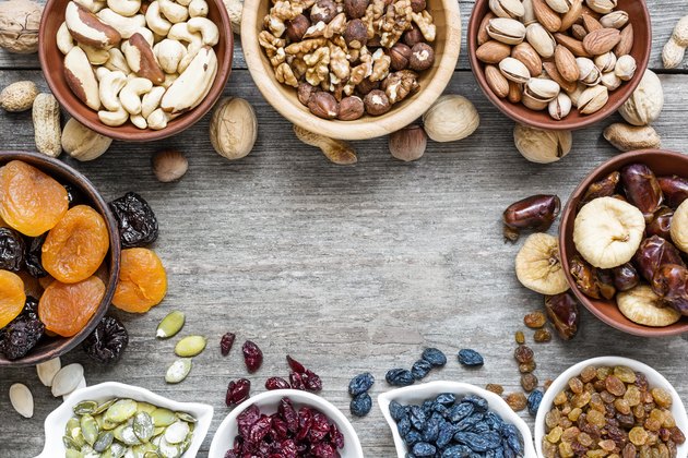 Mix of dried fruits and nuts on rustic wooden background