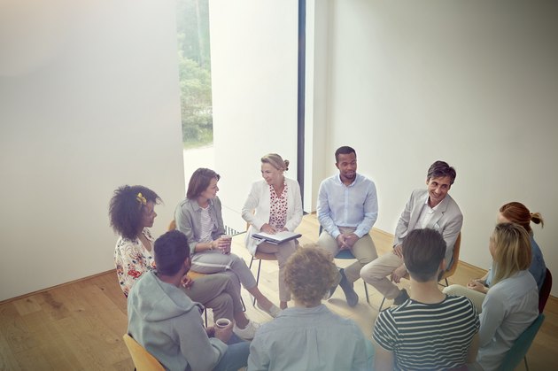 People talking in a circle in group therapy session