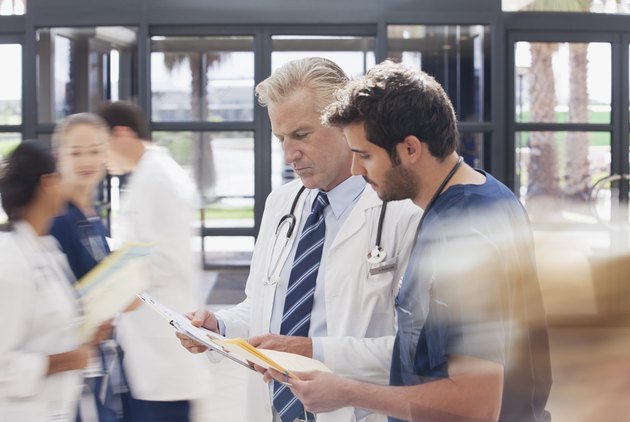 Doctor and nurse reviewing medical record in hospital