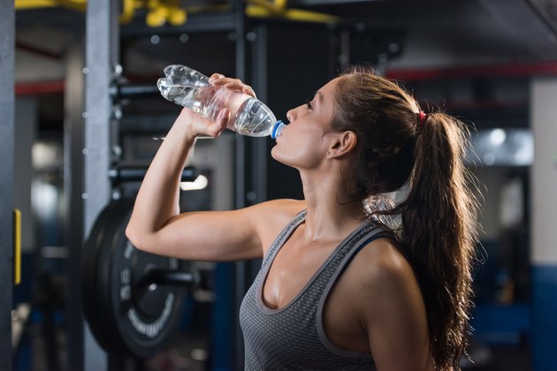 Woman at the gym drinking water
