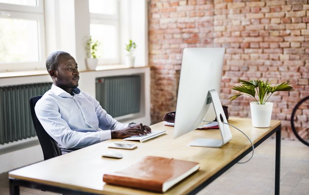 Businessman using computer at desk in office