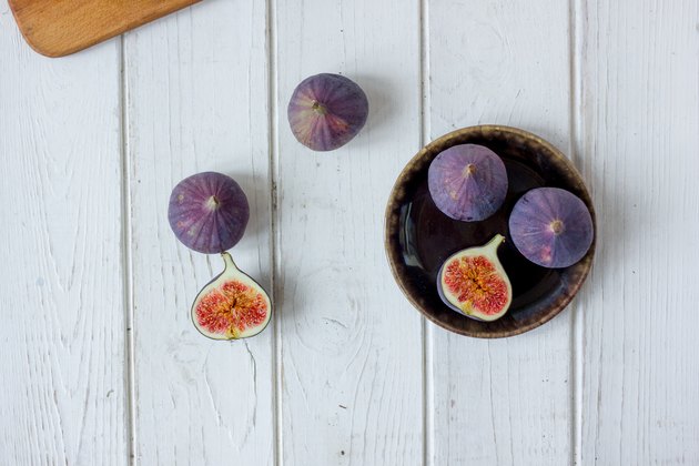 White table with fig fruit over it.