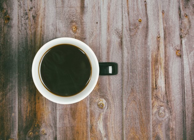 Directly Above Shot Of Black Coffee On Wooden Table