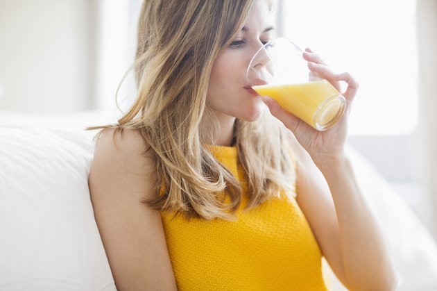 Woman drinking orange juice, sugary foods