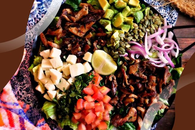 Keto Carnitas Salad with avocado and tomato in a blue patterned bowl