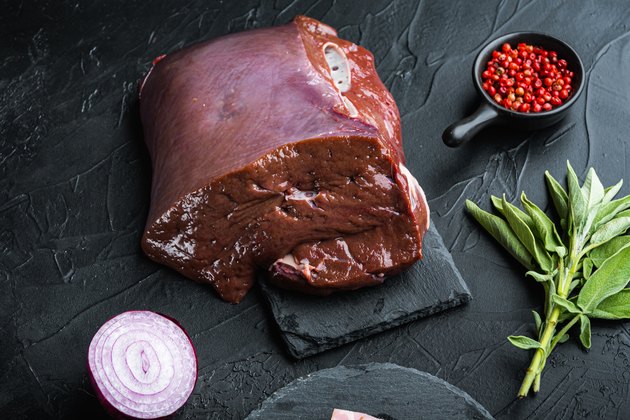 Liver on cutting board with onion.
