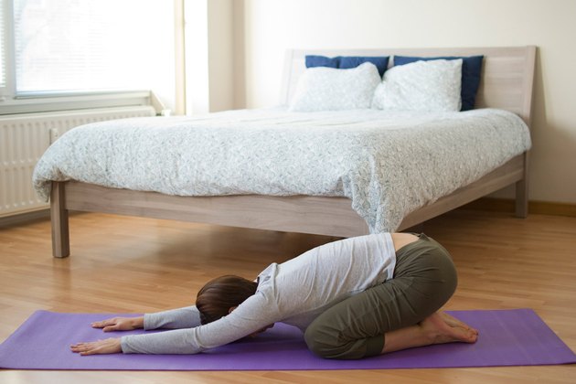 Woman demonstrating how to do Child's pose yoga for sleep