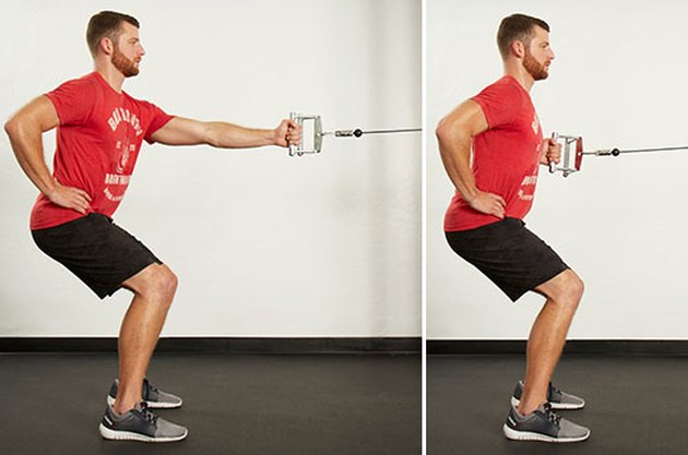 Man performing single-arm cable row on the cable machine