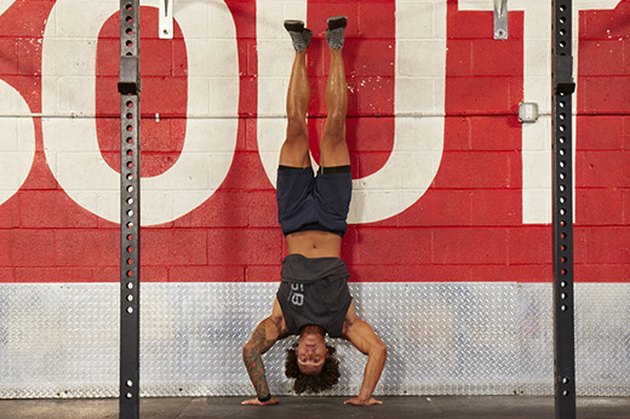 Man performing handstand push-ups.