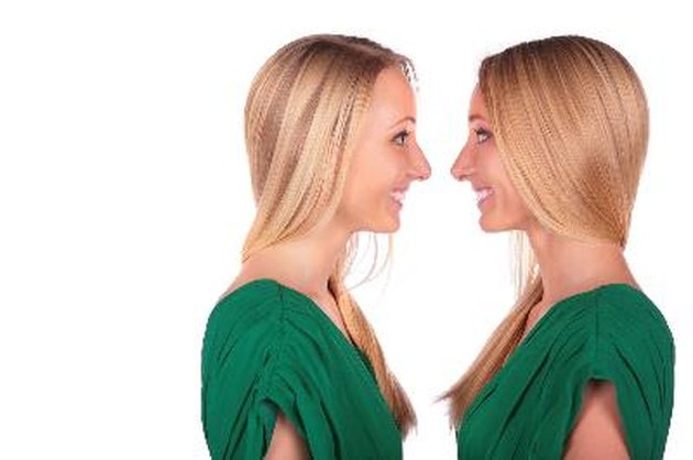 Twin girls smiling face-to-face