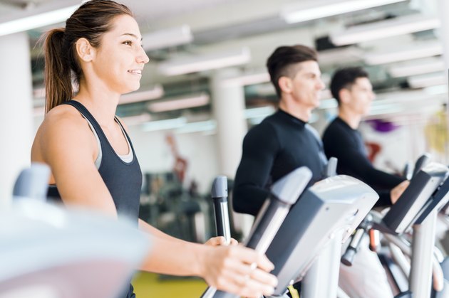Beautiful fit young woman working out on a stepper