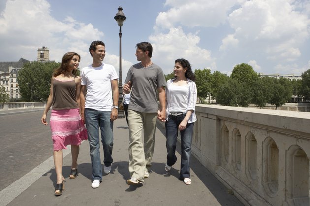 France, Paris, two couples crossing bridge