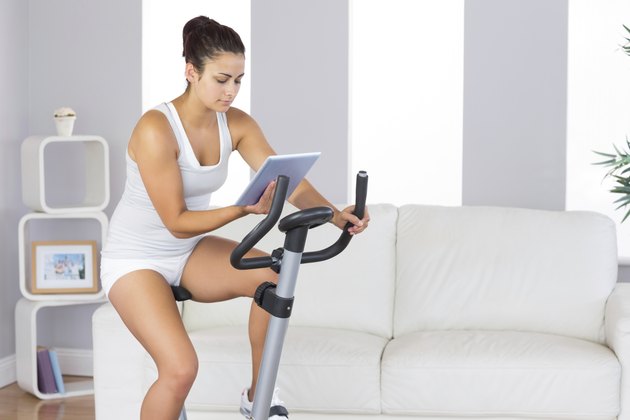 Young woman training on exercise bike