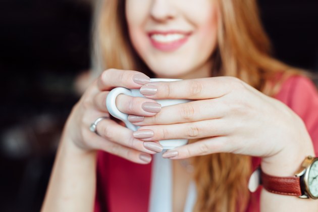Woman drinking coffee in a cafe