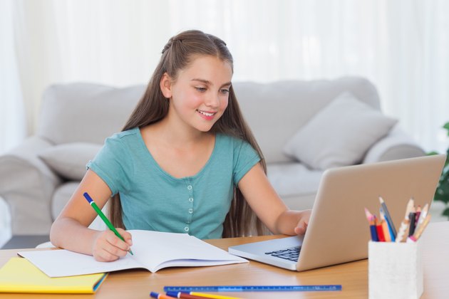 Little girl doing her homework at home