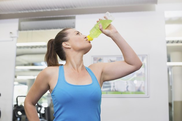 Fit brunette drinking energy drink