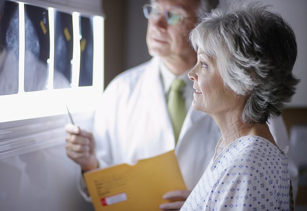 Doctor Discussing X-Rays with Middle Aged Woman