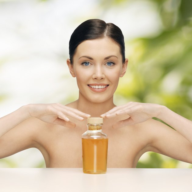 beautiful woman with oil bottle