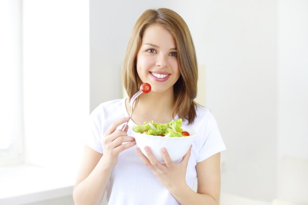 Teenager girl eating salad