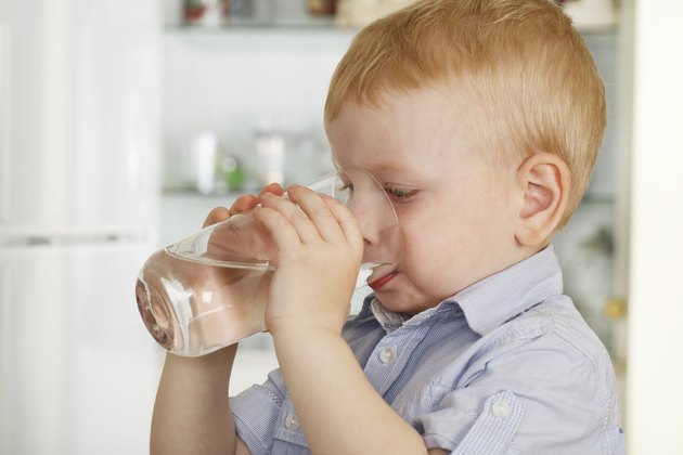 little boy drinks water