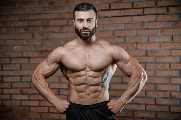 Fitness instructor handsome man in the gym gain muscle healthcare lifestyle sexy caucasian man bodybuilder work out naked body with tattoo