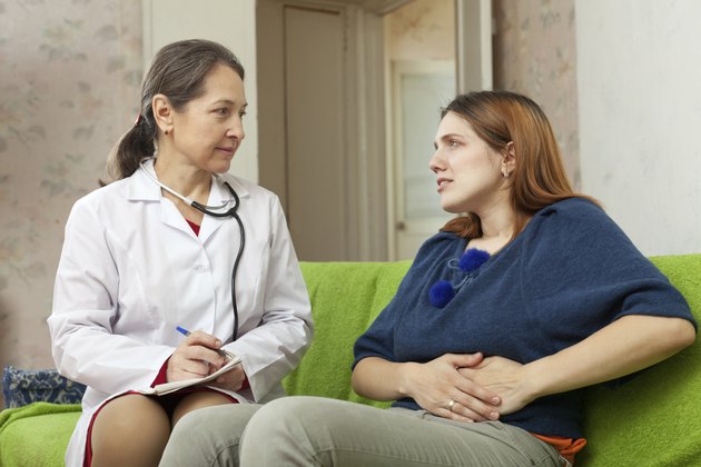 Woman complaining to doctor about pain