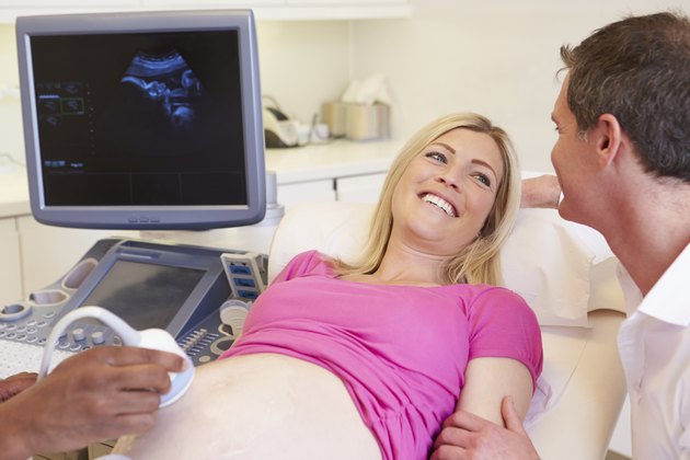 Pregnant Woman And Partner Having 4D Ultrasound Scan