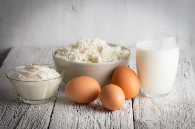 Fresh dairy products and eggs on rustic wooden table