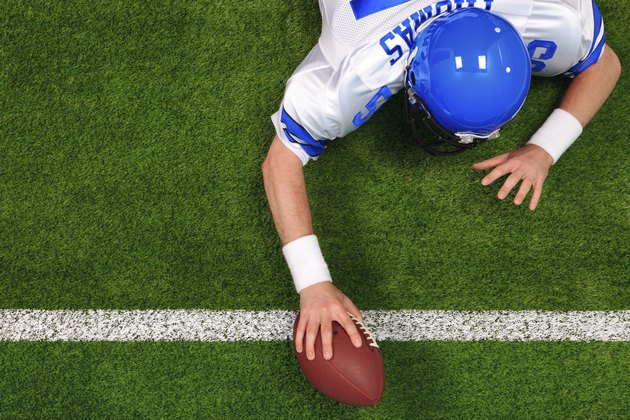 Overhead American football player one handed touchdown