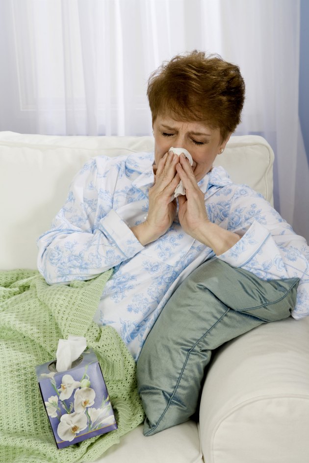 Woman blowing nose