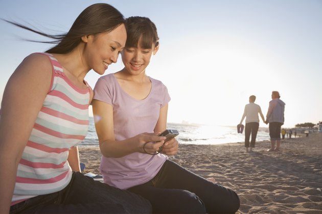 Mother and Daughter looking at camera on the beach