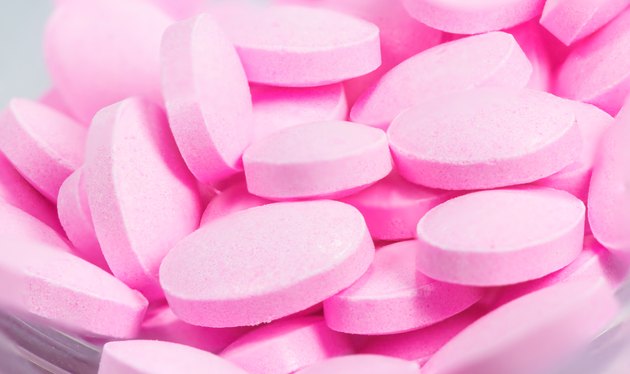 The pink tablets isolated on white background