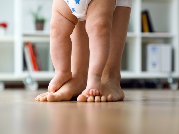 Mother and baby legs. First steps.
