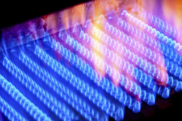 fire burns from a gas burner inside the boiler.