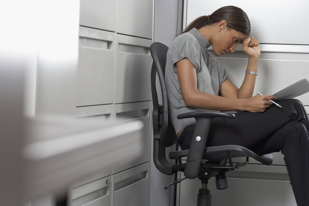 Side profile of a businesswoman suffering from a headache