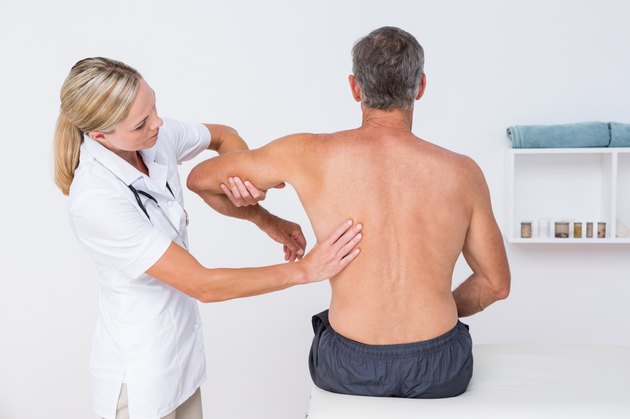 Doctor examining her patient arm